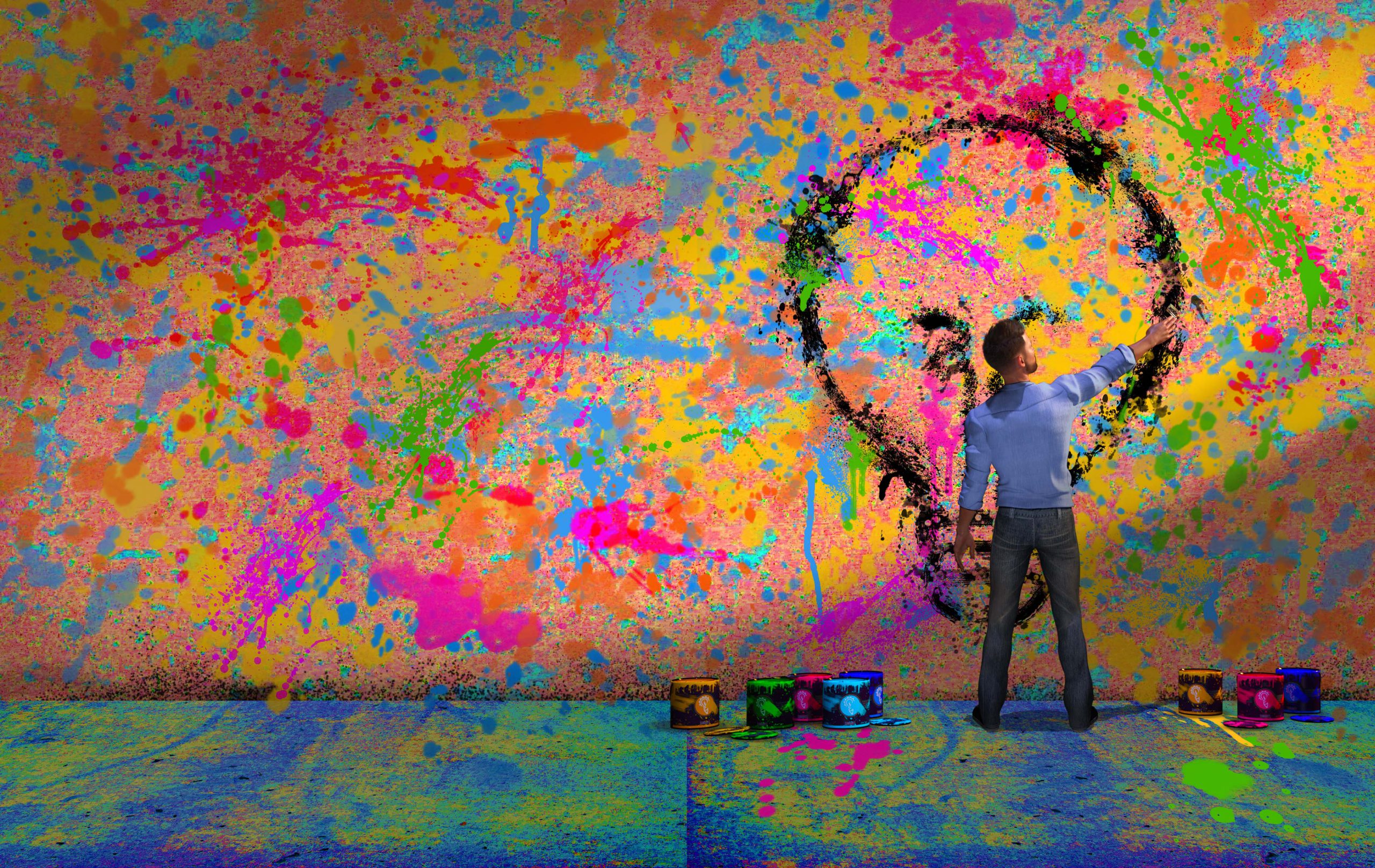man painting a lightbulb image on a multicolored wall
